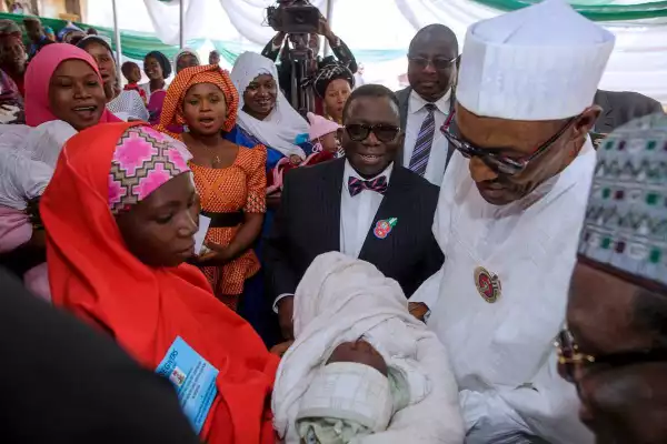 Photo: Buhari Carries First Child To Be Delivered At Kuchigoro, Named Muhammed Buhari
